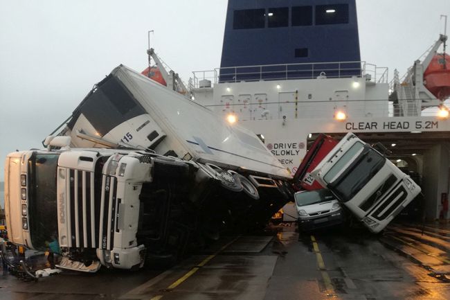 Toppled trucks and crushed van on deck