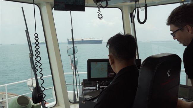 PSA Marine Tug Master and Thomas monitoring how the smart navigation system manouevres the harbour tug during sea trials