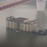5 storey building restaurant floating downstream in china _ non text