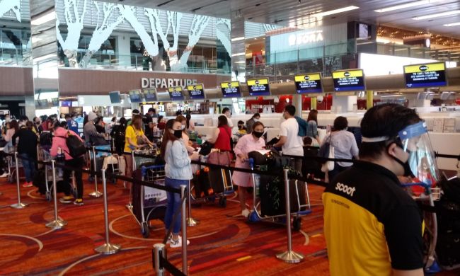 Filipino repatriates checking in for the Scoot TR 1390 flight for Manila last 27 July. Photo _ Raul Macapinlac