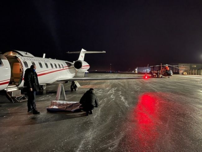  carries an injured man toward an awaiting Guardian Flight Alaska aircraft crew in Cold Bay, Alaska, Wednesday, Dec. 30, 2020.