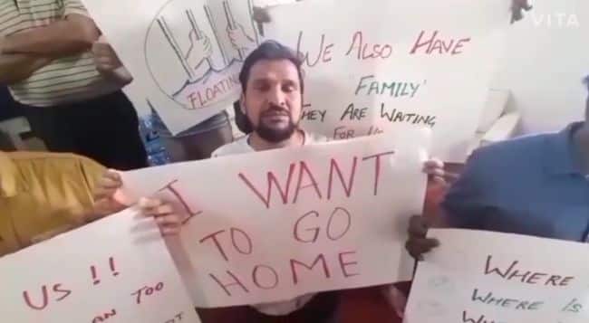 stranded seafarer for 18 months with board saying, "I want to go home"