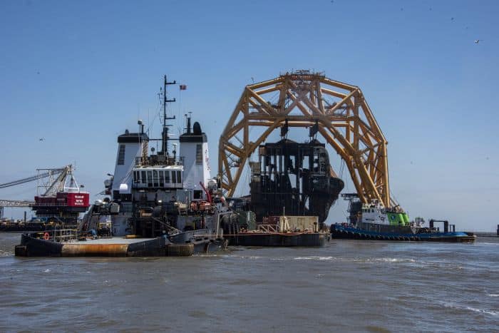 The Tugs Kurt J. Crosby and Caitlin maneuver the Barge 455-7 under Section Seven of the Golden Ray wreck on Monday. St. Simons Sound Incident response photo