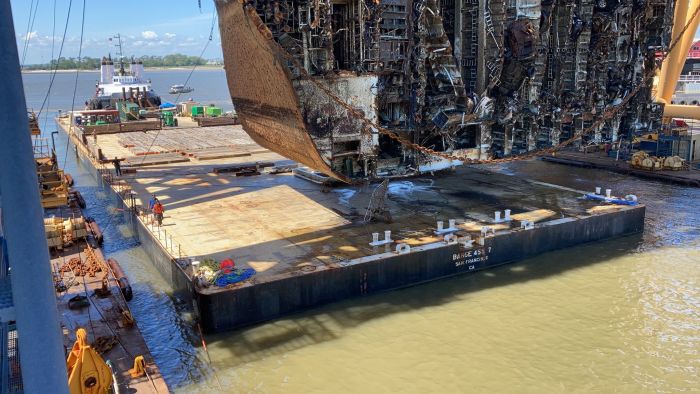 Wreck removal personnel observe Section Seven of the Golden Ray wreck as the Tug Kurt J. Crosby maneuvers the Barge 455-7 underneath