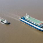 Inland vessel sailing muddy brown waters