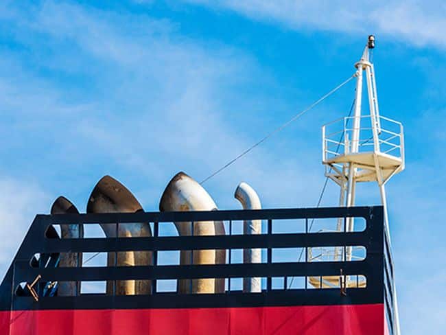 Chimneys of a cargo ship against clean sky