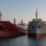 Cargo Ship Allides With Historic Yacht Galeb In Port Of Rijeka